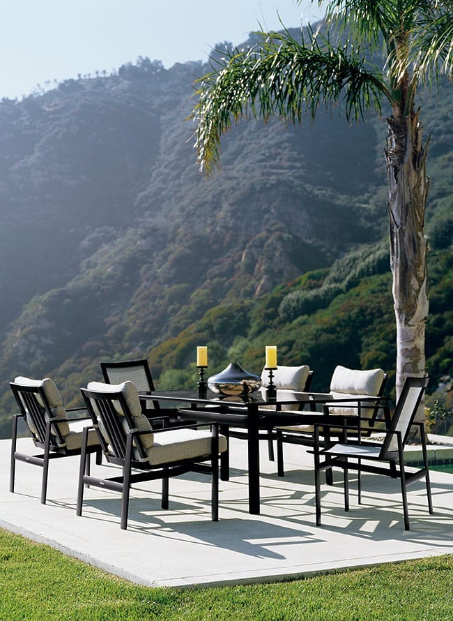 Parkway outdoor patio dining set from Brown Jordan set up on a concrete patio with a beautiful mountain-view