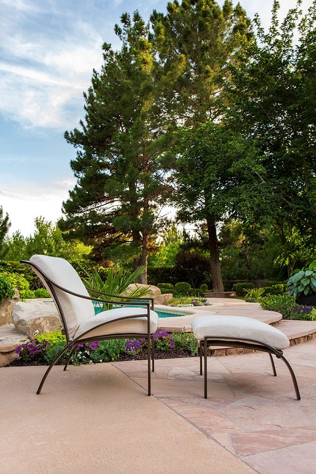 Pasadena cushion on outdoor furniture set from Brown Jordan set up on concrete and stone lanai in a garden