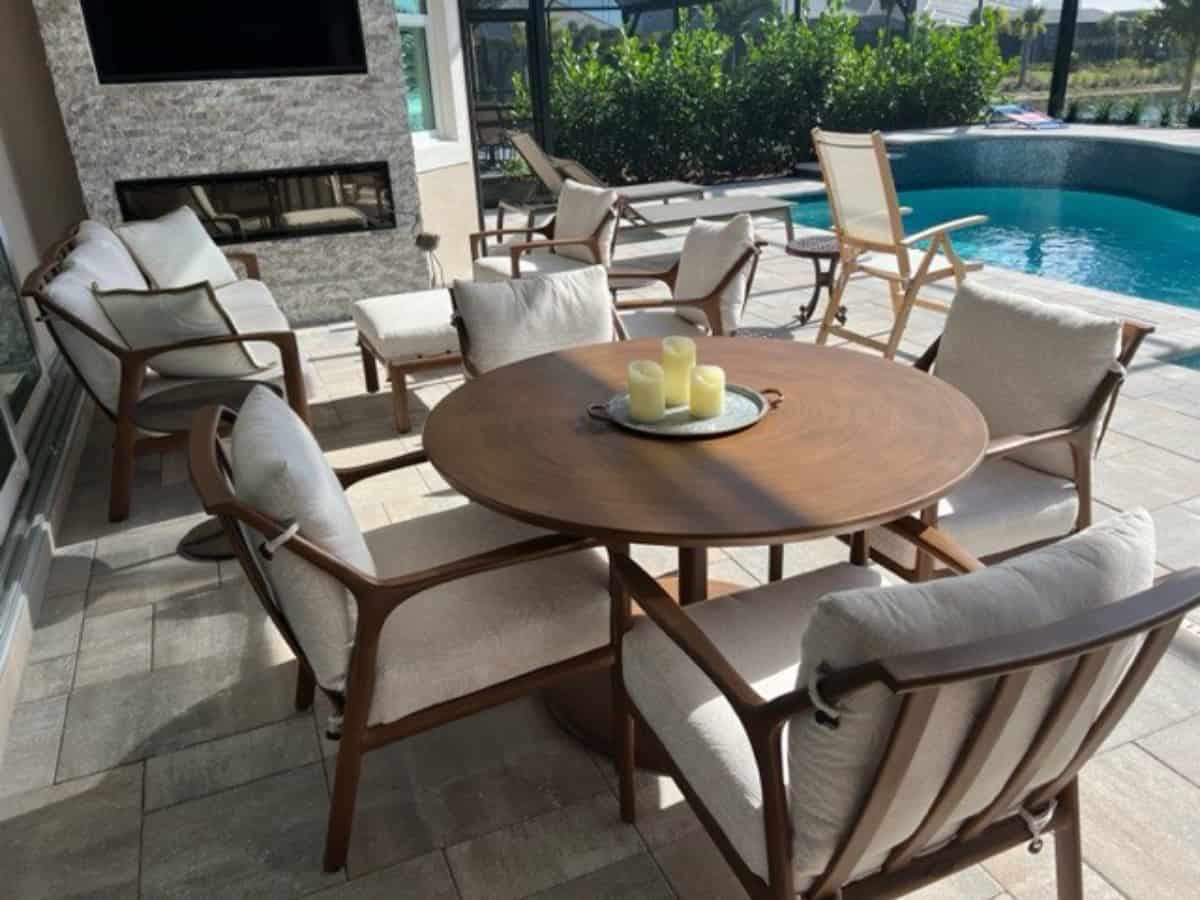 Castelle outdoor dining set and patio set in lanai near pool