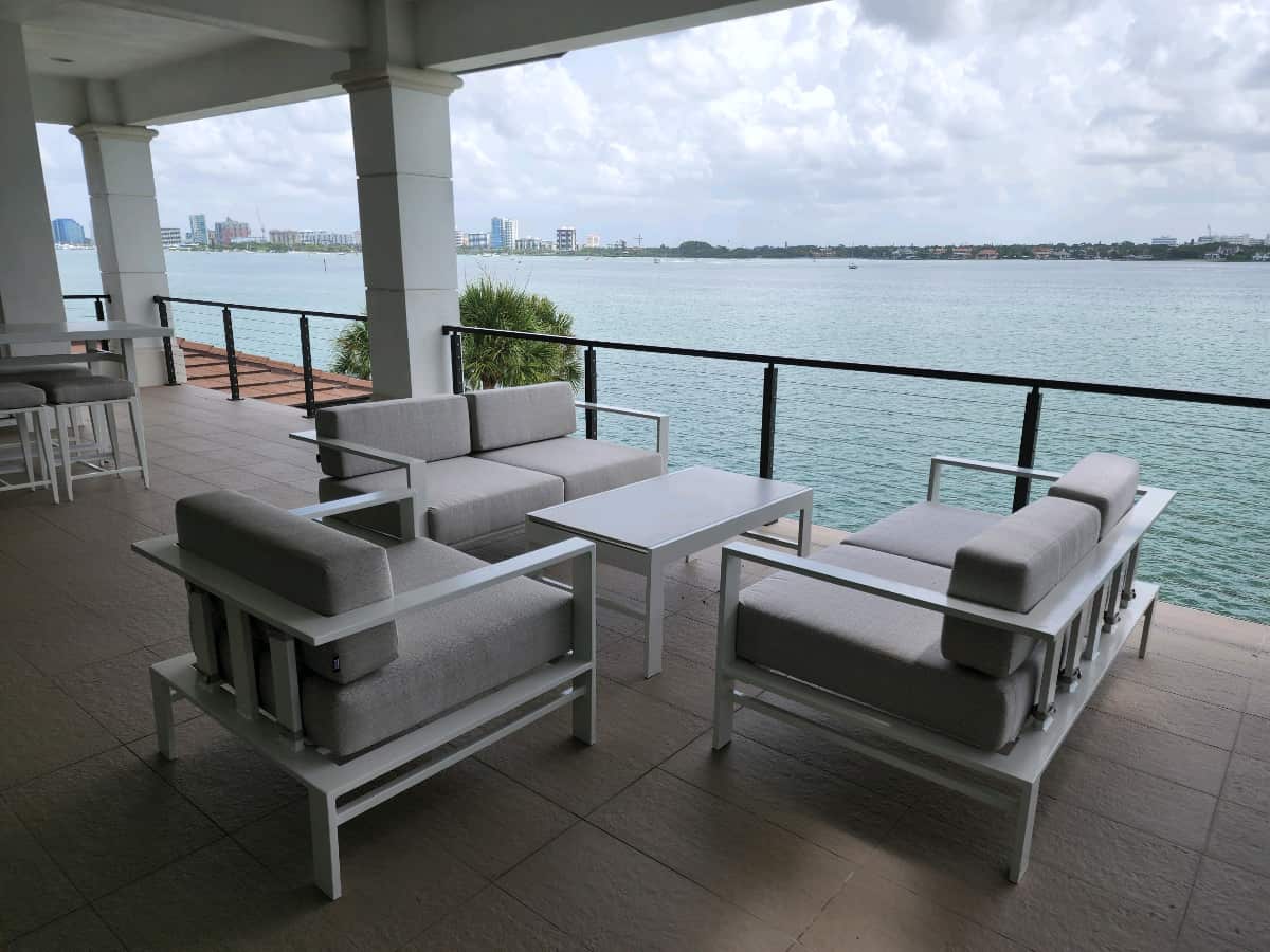 Pavilion patio set on back patio of house with waterfront view