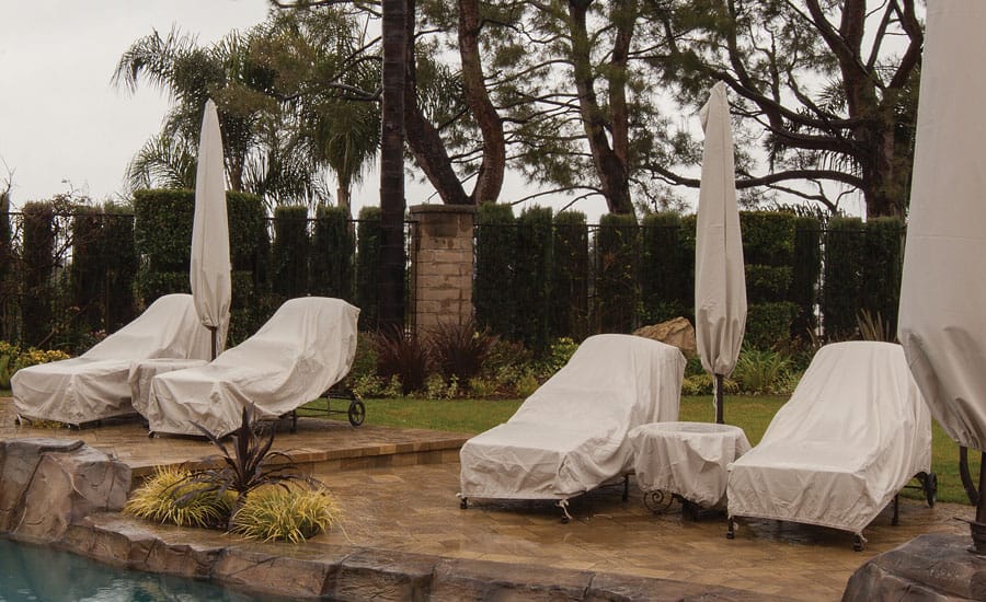 protective furniture covers on outdoor loungers and umbrellas